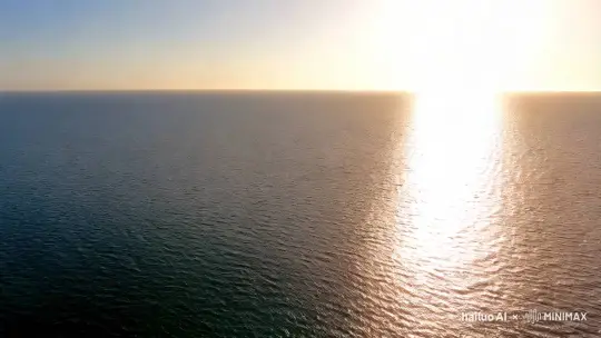 画面以一个宁静的海面开始，阳光从天空洒下，海面波光粼粼。镜头从高处俯瞰，海面平静如镜，远处可以看到海天一色的景象。
镜头缓慢向下移动，逐渐接近海面。随着镜头的下降，观众可以感受到从空中俯瞰到海面的过渡，海面的细节逐渐变得清晰。
镜头穿过海面，进入水下世界。画面从明亮的海面逐渐过渡到水下的幽暗环境，光线逐渐减弱，营造出一种神秘而宁静的氛围。
镜头继续深入，观众开始看到各种各样的鱼群在水中游动。镜头缓慢移动，捕捉到鱼群的动态，鱼儿们在水中自由穿梭，展现出它们的优雅和活力。
视频以一个缓慢上升的镜头结束，从水下回到海面，最后回到天空。镜头逐渐远离海面，海面再次变得平静，阳光洒在海面上，画面渐渐淡出。
整个视频的氛围从宁静的海面逐渐过渡到神秘的水下世界，最后回到宁静的海面，营造出一种探索和发现的旅程感。 by Hailuo AI Video Generator