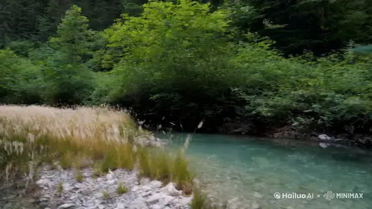 全景平移镜头 | 一条清澈的溪流穿过山林，水面在山风的吹拂下泛起层层涟漪，溪边的水草也随风摇曳，仿佛在与溪流共奏一曲自然之歌。 | 山林溪流、山风与涟漪、摇曳的水草 | by Hailuo AI Video Generator