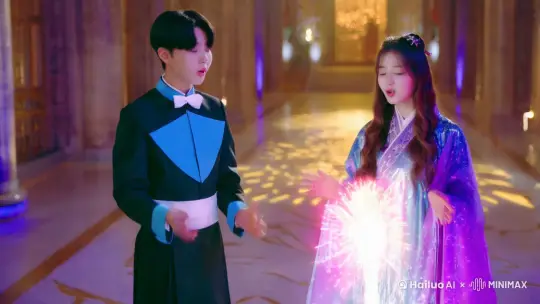 身穿黑蓝色管家服，黑色头发的23岁年轻男青年，正在与身穿魔法长袍的21岁披肩长发女青年合唱，他们一边变幻着烟花魔法一边唱歌 by Hailuo AI Video Generator