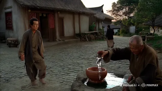 一天，一个衣衫褴褛的旅人路过村子。他面容憔悴，步履蹒跚，显然已经走了很远的路。旅人走到村口，看到一位正在井边打水的老人，便上前恳求道：“老人家，我走了很远的路，已经几天没有喝到水了，能否给我一碗水喝？”

老人抬头看了看旅人，见他满脸疲惫，心中不忍，便说：“年轻人，我们村子里的井水也不多了，不过你既然来了，我总不能见死不救。你等着，我去给你舀一碗水。”

老人转身回到家中，拿了一个破旧的陶碗，从水缸里舀了半碗水，递给旅人。旅人接过水碗，感激地说：“谢谢老人家，您的大恩大德，我永世不忘。”

旅人喝完水后，对老人说：“我是一个云游四方的道士，因缘际会来到此地。您如此善良，我愿为您做一件事，以报答您的恩情。”

老人笑了笑，说：“我不需要什么报答，只希望你一路平安。”

道士却说：“老人家，您虽然不求回报，但善有善报。我见您家中贫寒，井水又不多，我愿为您施法，让这口井永不干涸。”

老人半信半疑，但见道士神情坚定，便说：“既然如此，那就多谢道长了。”

道士走到井边，双手合十，口中念念有词。不一会儿，井中突然涌出一股清泉，水流源源不断。村民们闻讯赶来，看到这奇迹般的一幕，纷纷向道士道谢。

道士对村民们说：“这口井从此以后将永不干涸，但你们要记住，饮水思源，莫要浪费。同时，也要像这位老人家一样，乐善好施，积德行善。”

村民们纷纷点头称是。道士说完，便化作一道清风，消失得无影无踪。 by Hailuo AI Video Generator