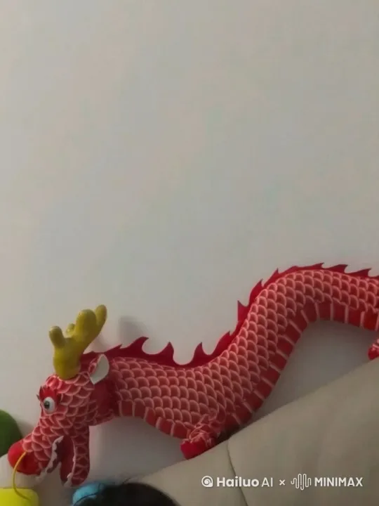 “红色的大龙在阳光照耀下缓缓扇动其强健的翅膀，逐渐加速，优雅地升入点缀着朵朵白云的蔚蓝天空，最终在高空中逐渐消散，化为点点光影，融入天际。” by Hailuo AI Video Generator