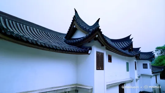 生成一栋江南古宅，以白墙黛瓦为主要特征，屋顶多为坡顶，屋檐翘起，形成优美的曲线。建筑整体风格典雅、精致，注重对称与平衡。
布局结构：古宅采用“三合院”的布局，围绕天井展开。天井不仅是采光和通风的重要部分，也是家庭活动的中心。宅院内部常有多个厅堂，分为前厅、中厅和后厅，功能各异。
装饰细节：古宅的装饰极为讲究，木雕、砖雕、石雕等工艺精湛。门窗、梁柱、栏杆等处常有精美的雕刻图案，题材多为花鸟、山水、人物故事等，寓意吉祥。
园林景观：古宅附有私家园林，园内假山、池塘、亭台楼阁错落有致，植物种类丰富，四季景色各异。园林设计讲究“借景”，通过巧妙布局将自然景观引入宅院。 by Hailuo AI Video Generator