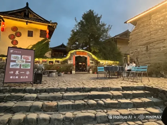 - **遗产降临**：普通白领苏夏意外继承外婆留下的深山老宅，带着疑惑回到阔别二十年的故乡。

- **诡异初现**：在老宅阁楼发现神秘铜镜，镜中映出的景象与真实场景存在细微差异，夜晚更出现外婆梳头的幻影。

- **时空错位**：旧照片里的全家福发生诡异变化，苏夏的身影逐渐消失，镜中影像却愈发清晰，暗示着可怕的替身仪式。

- **宿命轮回**：铜镜上的生辰刻字与苏夏完全吻合，揭晓外婆通过巫术延续生命的真相，最终将外孙女作为转生容器。

我们将重点描写苏夏在老宅阁楼发现铜镜后经历的诡异现象，通过镜中世界与现实世界的微妙差异，以及旧照片的恐怖变化，展现一个关于血脉诅咒与替生巫术的惊悚故事。

---
苏夏推开老宅大门时，铁锈味的霉气扑面而来。阳光从雕花窗棂斜射进来，在积灰的地板上切出菱形的光斑。她摸到墙上的电灯开关，钨丝灯泡闪了两下，在厅堂中央投下昏黄的光晕。

二十年了。

律师说外婆临终前指名把这栋祖宅留给她时，苏夏正坐在CBD的星巴克里修改PPT。此刻她站在挂着蛛网的厅堂中央，高跟鞋陷进吱呀作响的木地板，忽然想起五岁那年，自己就是在这里打翻了供桌上的香炉。

阁楼木梯发出不堪重负的呻吟。苏夏举着手机电筒往上爬，光束扫过转角处挂着的全家福。照片里穿旗袍的外婆抱着穿公主裙的自己，父亲的手还搭在母亲肩上——那时他们还没离婚。

顶楼的门把手缠着褪色的红绳。苏夏扯断绳结的瞬间，铜锁自动弹开，仿佛有人从里面解开了锁扣。

阁楼中央立着面等人高的铜镜。镜面蒙着灰黄雾翳，却仍能清晰映出苏夏的身影。她凑近擦拭镜面，忽然发现镜中自己的倒影慢了半拍——现实中的右手已经放下，镜中人却还在抬起胳膊。

冷汗顺着脊梁滑进衬衫后领。苏夏倒退两步撞上樟木箱，箱盖震开的瞬间，几十张泛黄照片雪花般飘落。她捡起最上面那张全家福，照片里本该是母亲的位置空了一块，像是被橡皮擦生生抹去。

手机突然震动，苏夏差点把照片甩出去。镜面映出她惨白的脸，以及身后无声转动的老式留声机。黄铜喇叭里飘出沙沙杂音，渐渐凝成外婆哼唱的童谣："月娘娘，辫子长，借张人皮裁衣裳......"

寒意从脚底漫上来。苏夏转身时，留声机的唱针明明停在最外侧。月光忽然穿透云层，铜镜泛起青色幽光，她看见镜中自己背后多了个梳发髻的影子。外婆穿着下葬时的绛紫色寿衣，枯枝般的手指正在给她编辫子。

照片从颤抖的指间滑落。苏夏发疯似的往楼下跑，却在二楼拐角撞翻供桌。香炉滚落台阶，和二十年前那个下午一模一样。她突然僵在原地——供桌上的牌位分明写着她的名字，朱砂字迹新鲜得像是昨天才写上。

阁楼传来木地板有节奏的吱呀声。苏夏摸到口袋里的照片，借着月光看清全家福正在褪色：父亲的身影开始模糊，而镜中那个"苏夏"的轮廓却愈发清晰。照片背面浮现出血色小楷，正是外婆的笔迹："以血为引，以镜为门，替生之术，十载为期。"

铜镜边缘的篆文在月光下泛红，苏夏终于看清那些缠绕的纹路——是生辰八字。她的生辰八字。

头顶传来编红头绳的沙沙声。苏夏摸到腕间外婆临终前硬给她戴上的铜镯，内侧密密麻麻刻满了替生咒文。留声机又开始转动，童谣混着苍老的笑声在梁柱间回荡："新衣裳换旧衣裳，小夏夏替婆婆看月亮......"

晨光初露时，老宅恢复了平静。律师推开虚掩的大门，看见穿绛紫色旗袍的少女正在擦拭铜镜。少女转过脸嫣然一笑，腕间铜镯与镜框同时泛起血光。

「继承手续都办妥了？」律师觉得少女的眼角纹路有些怪异，像是百岁老人才有的褶皱。

「辛苦您跑这一趟。」少女的声音忽远忽近，镜中倒影正在慢慢挺直佝偻的腰背，「我和这栋老宅，终于都等到新主人了。 by Hailuo AI Video Generator