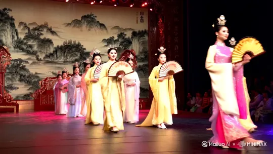 "中国小姐选美比赛"，璀璨夺目的舞台灯光聚焦于一群身穿华丽传统汉服的东方佳丽，她们个个面容姣好，身姿曼妙，正自信地走在T台上。佳丽们或手执折扇，或轻抚古筝，展现出中国古典女性的温婉与智慧。背景是一幅水墨山水画，与佳丽们的服饰相得益彰，营造出浓厚的中国古典氛围。整个场景采用纪实摄影风格，捕捉每一个动人瞬间，中景全景展现，让观众仿佛置身于比赛现场，感受那份独特的东方魅力。 by Hailuo AI Video Generator