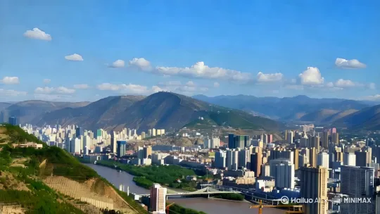 A cinematic aerial drone shot moving towards Gaolan Mountain in the background, starting from a wide city view of Lanzhou. The camera smoothly glides forward with subtle parallax effect, gradually revealing mountain details. Time-lapse clouds drift slowly across the sky, creating dynamic shadows on the terrain. The Yellow River flows with gentle water currents, reflecting sunlight glimmers. Maintain 4K resolution with realistic motion blur, cinematic color grading in earthy tones, and soft morning light illuminating traditional architecture in the foreground. Include subtle lens flare when passing sunlit areas. by Hailuo AI Video Generator