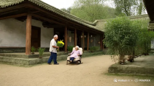 一个干净利落的农村小院的屋檐下，一位衣着朴素的老太太躺在躺椅上。镜头缓缓拉近。一位矍铄的老人拿着一束野花笑嘻嘻的递到老太太手里。老人满脸爱意，老太太满脸幸福满足，镜头往一个方向慢慢移开整个小院呈现在在镜头中，镜头中缓缓出现文字：爱，很简单。 by Hailuo AI Video Generator