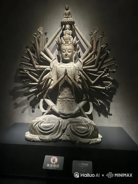【千手观音:千臂化慈航 一眼照大千】
掌心托日月,千臂织星河。
当梵音穿透时光帷幕,敦煌壁画中的流光溢彩骤然苏醒。千手观音以莲台为基,金身巍峨,千重法相次第绽放:或结无畏印驱散迷障,或持净瓶遍洒甘露,宝镜映照人间冷暖,法轮转动天地清明。
千手非为彰显神力,而是将无量慈悲拆解成触手可及的温柔——每一掌心都盛开着渡人的舟楫,每一指尖都缠绕着解厄的丝线。千眼非为洞穿轮回,而是将悲悯凝成晨露,滴落在每个仰望者的眉间。那些层叠舒展的金色手臂,原是众生祈愿的具象,在香火氤氲中筑起慈悲的巴别塔。
我们总在寻找具象的神迹,却不知真正的救赎早已化作:孩童掌心接住的落花,游子衣襟沾染的炊烟,暗夜窗前不灭的灯火。千手观音的造像,本就是先民将人间善意的总和,熔铸成永恒的精神图腾。
此刻驻足凝望,但见鎏金衣袂间流转着千年祈愿——
千手非千手,是天地间永不熄灭的善意星火;
千眼非千眼,是尘世里始终明亮的温柔注视。 by Hailuo AI Video Generator