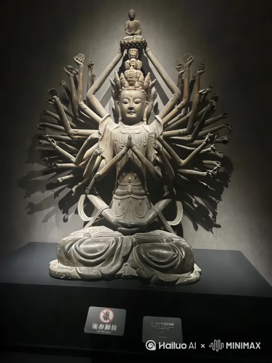 【千手观音:千臂化慈航 一眼照大千】
掌心托日月,千臂织星河。
当梵音穿透时光帷幕,敦煌壁画中的流光溢彩骤然苏醒。千手观音以莲台为基,金身巍峨,千重法相次第绽放:或结无畏印驱散迷障,或持净瓶遍洒甘露,宝镜映照人间冷暖,法轮转动天地清明。
千手非为彰显神力,而是将无量慈悲拆解成触手可及的温柔——每一掌心都盛开着渡人的舟楫,每一指尖都缠绕着解厄的丝线。千眼非为洞穿轮回,而是将悲悯凝成晨露,滴落在每个仰望者的眉间。那些层叠舒展的金色手臂,原是众生祈愿的具象,在香火氤氲中筑起慈悲的巴别塔。
我们总在寻找具象的神迹,却不知真正的救赎早已化作:孩童掌心接住的落花,游子衣襟沾染的炊烟,暗夜窗前不灭的灯火。千手观音的造像,本就是先民将人间善意的总和,熔铸成永恒的精神图腾。
此刻驻足凝望,但见鎏金衣袂间流转着千年祈愿——
千手非千手,是天地间永不熄灭的善意星火;
千眼非千眼,是尘世里始终明亮的温柔注视。 by Hailuo AI Video Generator