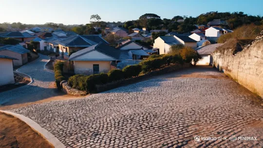 **开场镜头（0:00-0:05）**  
*远景·慢推镜头·清晨*  
画面从高空俯瞰一个寂静的南方村庄，镜头在村子上慢慢拉近，左移镜头，镜头贴着街道地面前进。 by Hailuo AI Video Generator