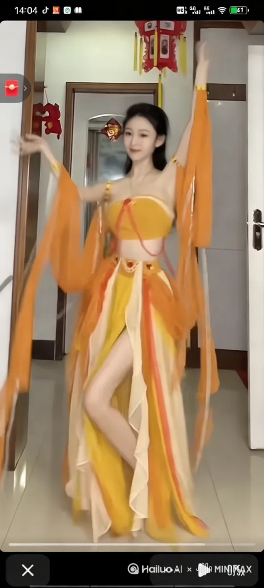 图片中的人物身穿一套鲜艳的橙色和黄色相间的传统服饰，看起来像是汉服或类似的民族服饰。她站在室内，背景有一些红色的装饰物，可能与春节或其他节日有关。她的姿势优雅，手臂高高举起，似乎正在进行一段优美的舞蹈。

要让这个人物跳起舞来，可以想象她随着音乐的节奏翩翩起舞。她的长袖随着动作飘动，形成优美的弧线。她的身体轻盈地旋转，裙摆随之飞扬，展现出流动的美感。她可能会做一些优雅的手势和脚步动作，比如轻盈的步伐、转圈和挥手等。

她的表情也会随着舞蹈的变化而变化，时而微笑，时而专注，展现出对舞蹈的热爱和投入。整个舞蹈动作流畅自然，充满韵律感，让人感受到一种古典的美和艺术的魅力。

通过她的舞蹈，可以感受到一种文化的传承和艺术的表达，仿佛将人带入了一个充满诗意和幻想的世界。她的每一个动作都充满了力量和美感，让人不由自主地被吸引和感动。[左移,右摇,跟随] by Hailuo AI Video Generator